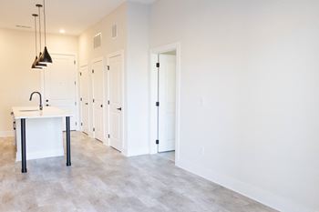 A kitchen with a table and chairs in the middle of the room.